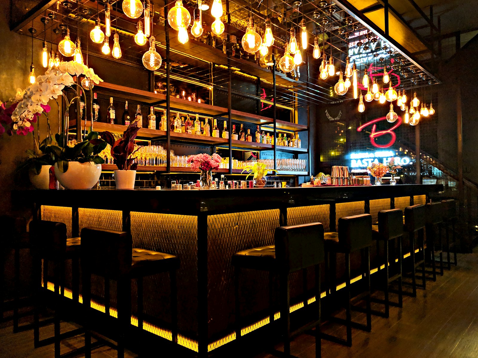 Late-night bar interior with hanging bulbs